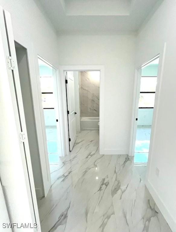 1218 Eclat St E, Lehigh Acres, FL 33974 - corridor with baseboards and marble look tile flooring
