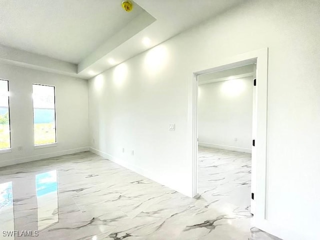 1218 Eclat St E, Lehigh Acres, FL 33974 - unfurnished room featuring light marble finish flooring, recessed lighting, and a raised ceiling