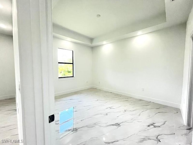 1218 Eclat St E, Lehigh Acres, FL 33974 - unfurnished room featuring a raised ceiling and marble finish flooring