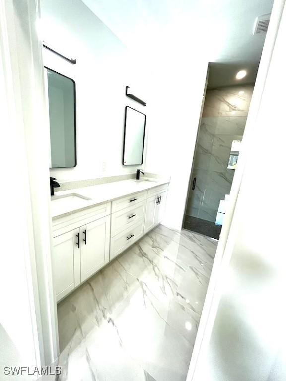 1218 Eclat St E, Lehigh Acres, FL 33974 - bathroom with marble finish flooring, a marble finish shower, and double vanity