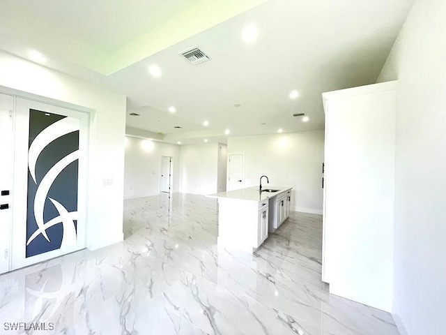 1218 Eclat St E, Lehigh Acres, FL 33974 - kitchen with recessed lighting, white cabinetry, a kitchen island with sink, open floor plan, and light countertops