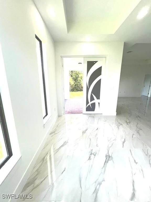 1218 Eclat St E, Lehigh Acres, FL 33974 - unfurnished room with a tray ceiling and marble finish floors