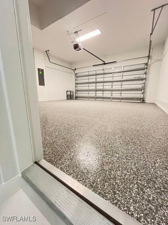 1218 Eclat St E, Lehigh Acres, FL 33974 - garage with a garage door opener and electric panel