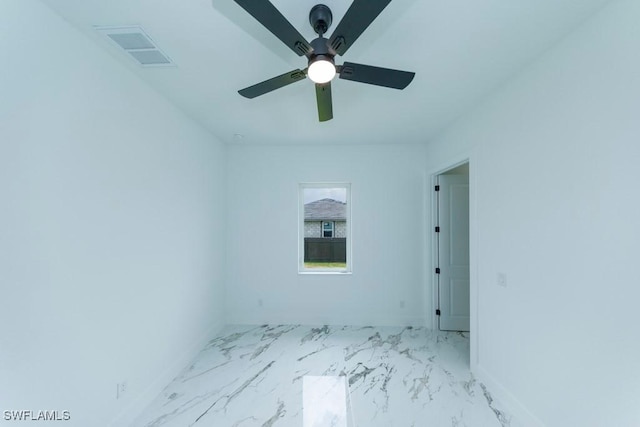 341 NE 31st Ter, Cape Coral, FL 33909 - unfurnished room with light marble finish flooring, ceiling fan, and baseboards