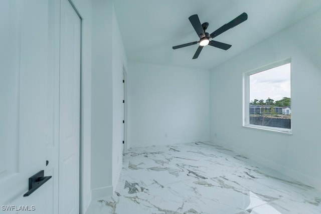 341 NE 31st Ter, Cape Coral, FL 33909 - unfurnished bedroom with baseboards, a ceiling fan, and marble finish floors