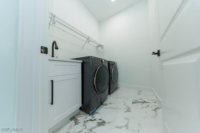 341 NE 31st Ter, Cape Coral, FL 33909 - laundry area with washing machine and dryer, light marble finish flooring, and baseboards