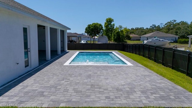 341 NE 31st Ter, Cape Coral, FL 33909 - view of swimming pool featuring a fenced backyard, a patio area, a hot tub, and a residential view