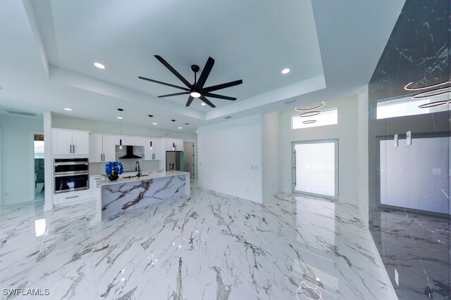 341 NE 31st Ter, Cape Coral, FL 33909 - unfurnished living room with a raised ceiling, a sink, recessed lighting, and a ceiling fan