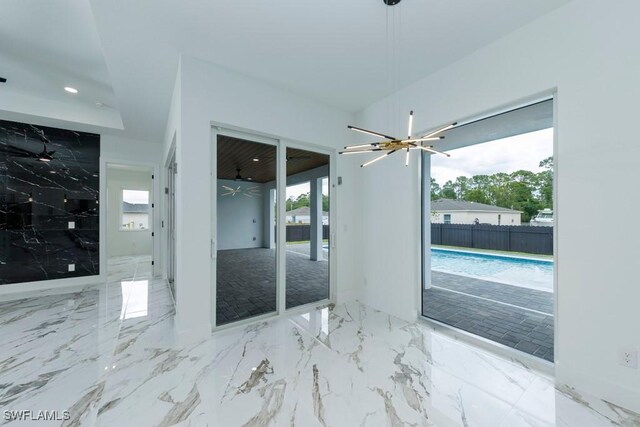341 NE 31st Ter, Cape Coral, FL 33909 - unfurnished room with a chandelier, marble tiled flooring, and recessed lighting