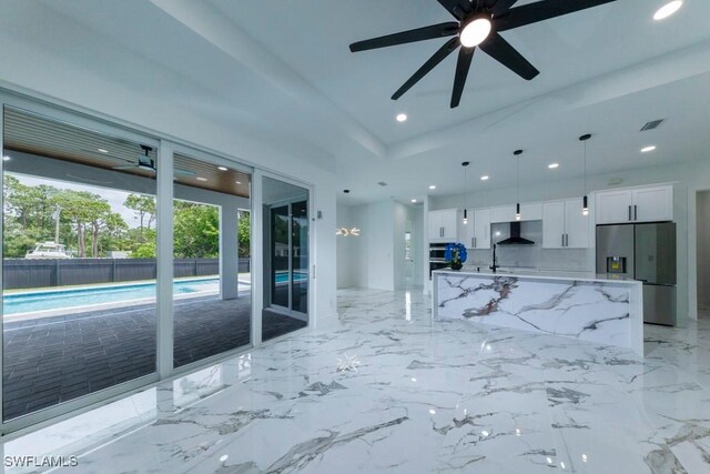 341 NE 31st Ter, Cape Coral, FL 33909 - unfurnished living room featuring ceiling fan, recessed lighting, and a sink