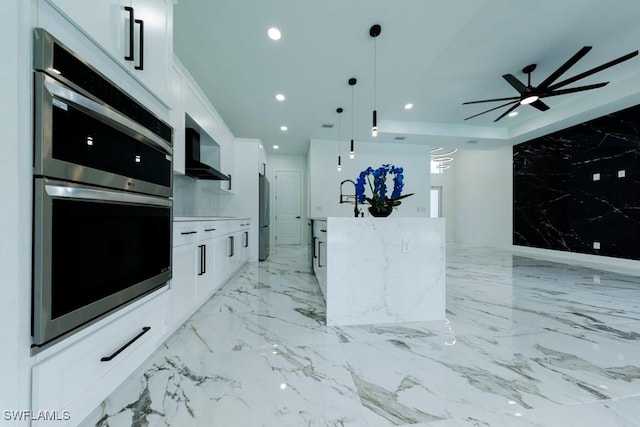 341 NE 31st Ter, Cape Coral, FL 33909 - kitchen with wall chimney range hood, stainless steel appliances, white cabinetry, recessed lighting, and ceiling fan