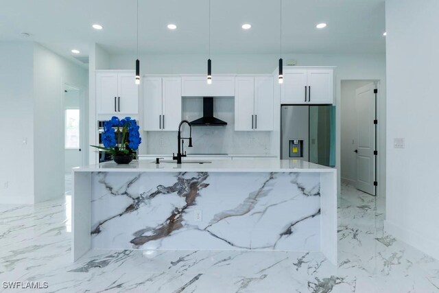 341 NE 31st Ter, Cape Coral, FL 33909 - kitchen featuring stainless steel fridge, a center island with sink, wall chimney range hood, recessed lighting, and light marble finish floors