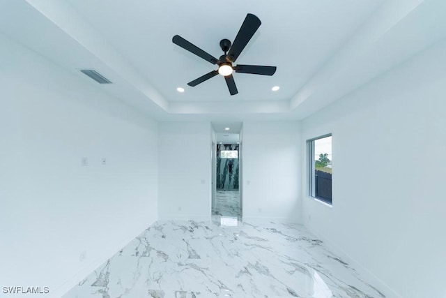 341 NE 31st Ter, Cape Coral, FL 33909 - empty room featuring recessed lighting, a ceiling fan, a raised ceiling, marble finish floors, and baseboards