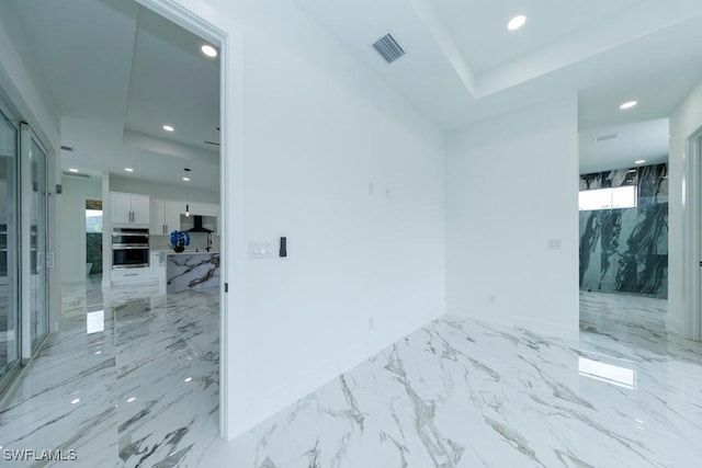 341 NE 31st Ter, Cape Coral, FL 33909 - empty room featuring light marble finish flooring, recessed lighting, baseboards, and a raised ceiling