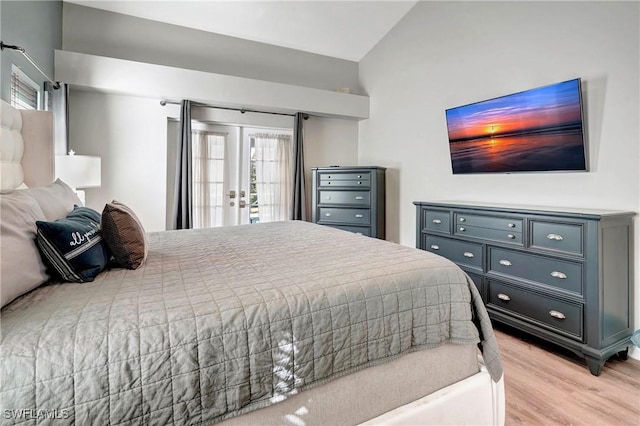 2128 SW 8th Ct, Cape Coral, FL 33991 - bedroom with light wood-style flooring, french doors, access to exterior, and vaulted ceiling