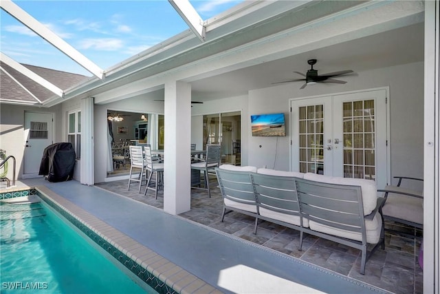 2128 SW 8th Ct, Cape Coral, FL 33991 - swimming pool with french doors, a ceiling fan, a patio, an outdoor living space, and a lanai