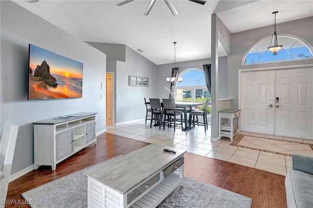 2128 SW 8th Ct, Cape Coral, FL 33991 - entrance foyer featuring a ceiling fan, a chandelier, tile patterned flooring, baseboards, and high vaulted ceiling