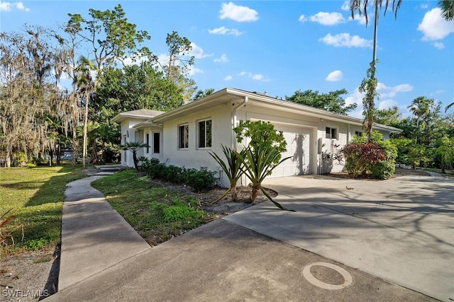4440 15th Ave SW, Naples, FL 34116 - ranch-style home with an attached garage, stucco siding, driveway, and a front lawn