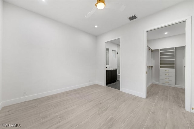 4440 15th Ave SW, Naples, FL 34116 - unfurnished bedroom with light wood-type flooring, a spacious closet, baseboards, a closet, and recessed lighting