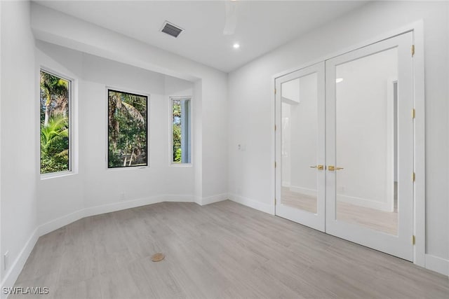 4440 15th Ave SW, Naples, FL 34116 - unfurnished bedroom featuring french doors, light wood-style floors, recessed lighting, and baseboards