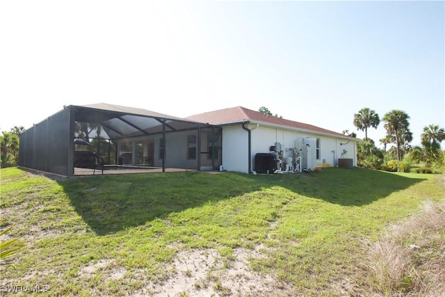 2640 36th Ave SE, Naples, FL 34117 - rear view of house featuring a lawn, central AC unit, and glass enclosure
