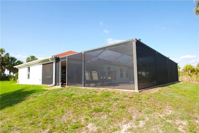 2640 36th Ave SE, Naples, FL 34117 - rear view of property featuring a yard and glass enclosure