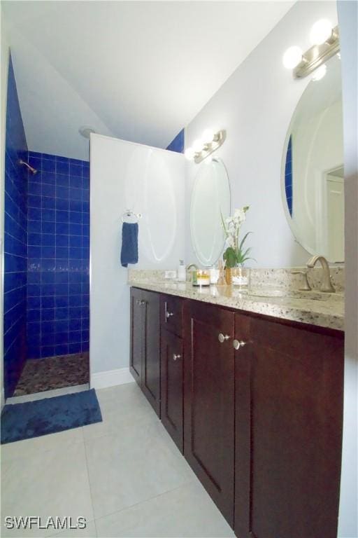 2640 36th Ave SE, Naples, FL 34117 - bathroom with tile patterned flooring, vanity, and a tile shower