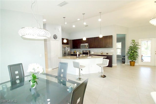 2640 36th Ave SE, Naples, FL 34117 - dining room with baseboards, a towering ceiling, light tile patterned floors, and recessed lighting