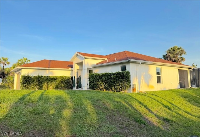 2640 36th Ave SE, Naples, FL 34117 - rear view of property featuring stucco siding and a yard