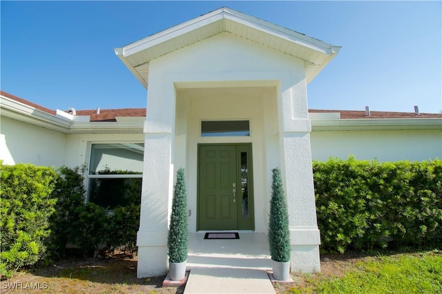 2640 36th Ave SE, Naples, FL 34117 - doorway to property featuring stucco siding