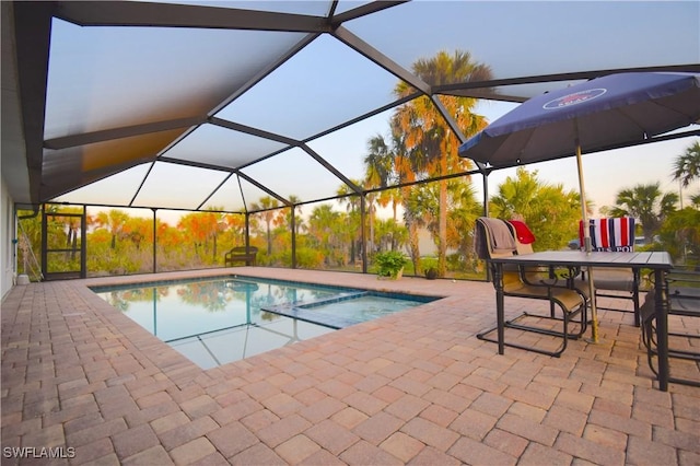 2640 36th Ave SE, Naples, FL 34117 - view of swimming pool featuring a patio, a pool with connected hot tub, and glass enclosure