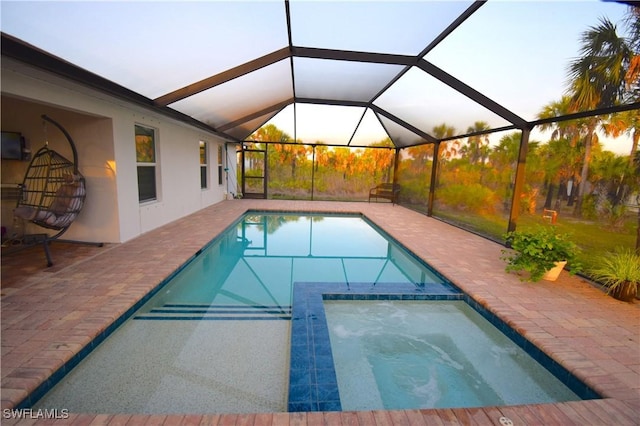 2640 36th Ave SE, Naples, FL 34117 - view of swimming pool with a patio area, a pool with connected hot tub, and glass enclosure