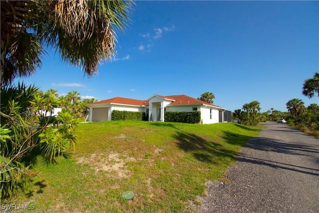 2640 36th Ave SE, Naples, FL 34117 - view of front facade with a front lawn