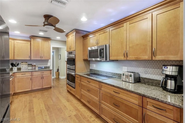 240 Palm River Blvd Unit C202, Naples, FL 34110 - kitchen featuring stainless steel appliances, ceiling fan, tasteful backsplash, stone countertops, and light wood-type flooring