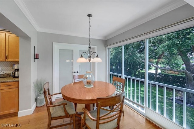 240 Palm River Blvd Unit C202, Naples, FL 34110 - dining area featuring light wood-type flooring, ornamental molding, baseboards, and a chandelier