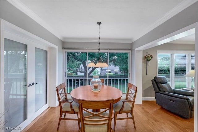 240 Palm River Blvd Unit C202, Naples, FL 34110 - dining room featuring light wood finished floors, french doors, crown molding, and baseboards