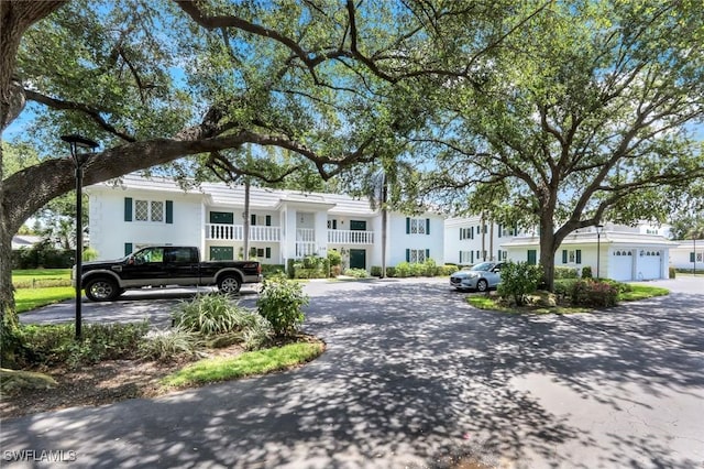 240 Palm River Blvd Unit C202, Naples, FL 34110 - view of front of home with stucco siding and uncovered parking