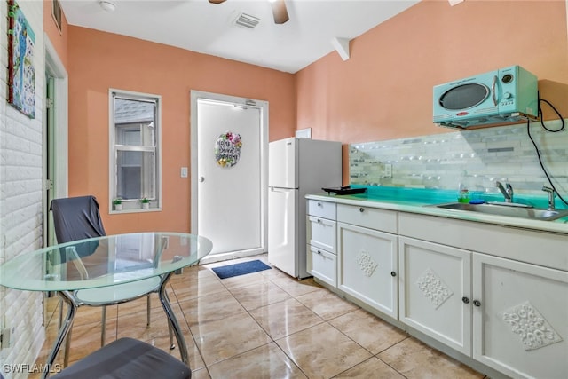 4617 Lombardy Ln, Naples, FL 34112 - kitchen featuring a sink, white cabinets, ceiling fan, light countertops, and tasteful backsplash