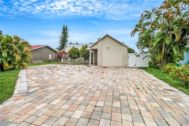 4617 Lombardy Ln, Naples, FL 34112 - view of patio featuring a gate and decorative driveway