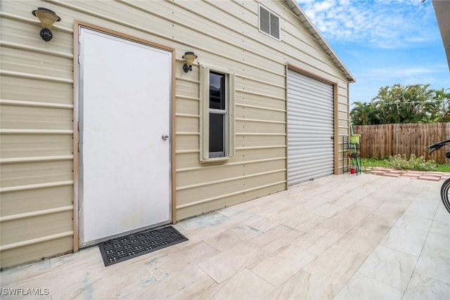 4617 Lombardy Ln, Naples, FL 34112 - view of exterior entry with fence and a patio