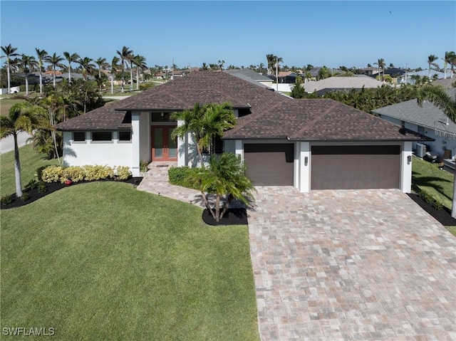 2711 SW 32nd St, Cape Coral, FL 33914 - prairie-style home with a shingled roof, a garage, a front lawn, and driveway