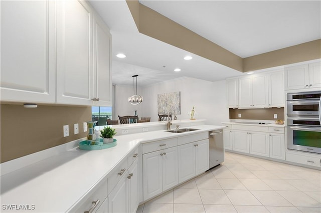 12701 Mastique Beach Blvd Unit 603, Fort Myers, FL 33908 - kitchen featuring stainless steel appliances, a sink, light countertops, recessed lighting, and white cabinetry