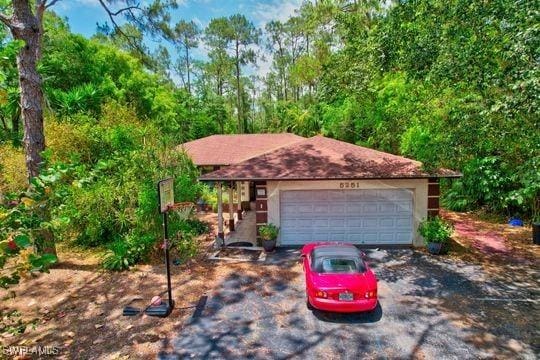 5251 Boxwood Way, Naples, FL 34116 - view of front facade featuring a garage
