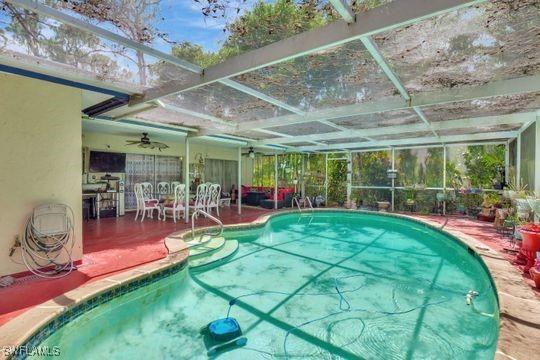5251 Boxwood Way, Naples, FL 34116 - outdoor pool featuring ceiling fan, a patio, and a lanai
