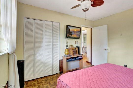 5251 Boxwood Way, Naples, FL 34116 - bedroom with a closet and a ceiling fan