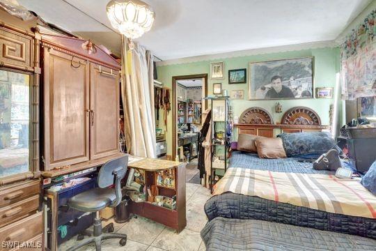 5251 Boxwood Way, Naples, FL 34116 - bedroom with a desk and light tile patterned floors