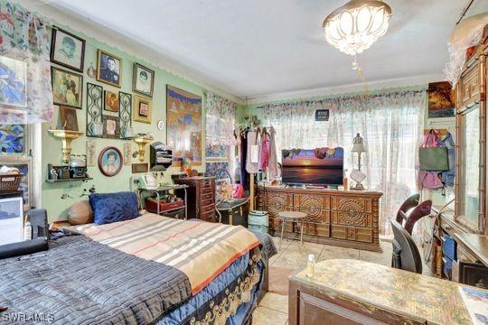 5251 Boxwood Way, Naples, FL 34116 - bedroom with tile patterned flooring and a chandelier