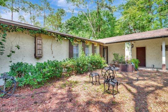 5251 Boxwood Way, Naples, FL 34116 - view of front facade with stucco siding