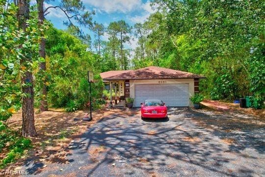 5251 Boxwood Way, Naples, FL 34116 - view of front facade with asphalt driveway