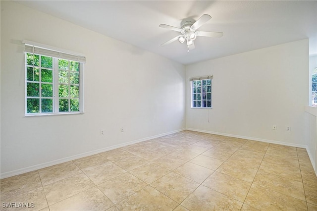 20273 Royal Villagio Ct Unit 204, Estero, FL 33928 - spare room featuring plenty of natural light, ceiling fan, light tile patterned floors, and baseboards